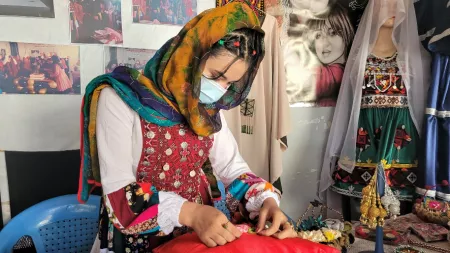 Afghanistan_Girl in traditional Afghan clothing sewing