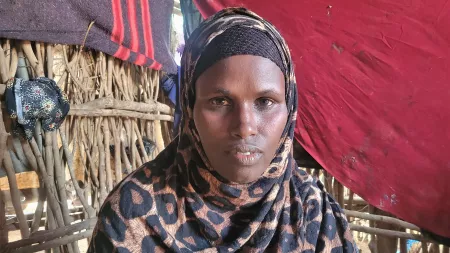 Kenya_Woman wearing leopard print hijab inside makeshift home in Dadaab