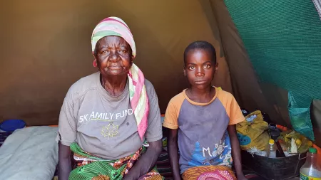 Zambia_Old lady sitting in IDP camp tent with young grandson