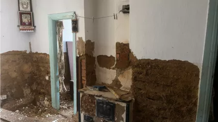Ukraine_Damaged apartment with dust and blue door frames