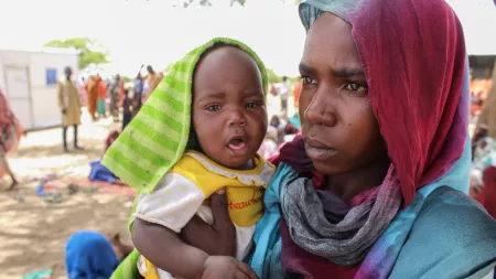 Woman holding baby in IDP camp in Chad