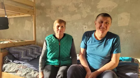Elderly woman and man sitting in shelter