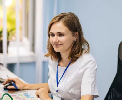 Woman sitting in an office in front of computer looking at another woman