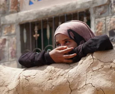 Yemeni girl looks over wall