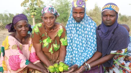 Women holding vegetables