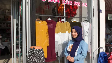 Shifa standing in front of a store