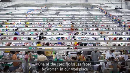 A shot from above showing several women working on sewing machines at desks.