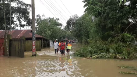 People walk in flooded area in Bangladesh