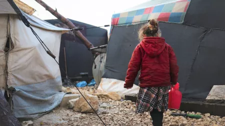 Girl carrying water in Syria