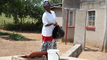 Woman collecting water in Zimbabwe