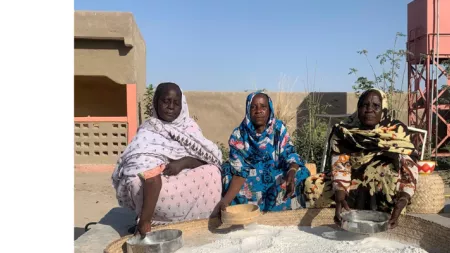 Three women processing food in Chad
