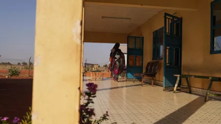 Woman carrying baby in hospital in South Sudan