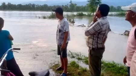 People looking at flooded area in Nepal