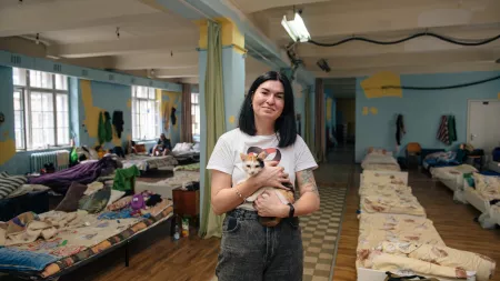 Victoria holds cat in the shelter she manages in Lviv, Ukraine