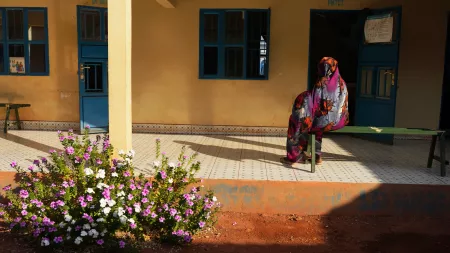 Woman sitting on bench in South Sudan