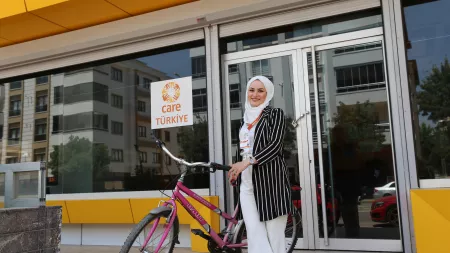 Sabah with her bike in front of the CARE Turkey office