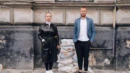 Maria and Bohdan standing side by side on a street