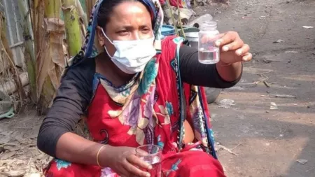 Woman holding glass of water in Bangladesh