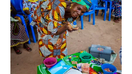 Ivorian lady next to money