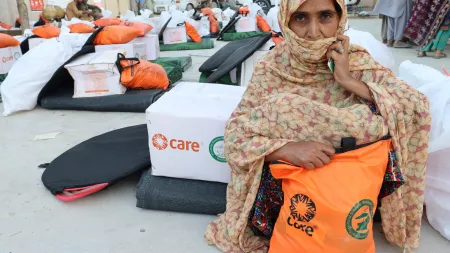 Woman with CARE Package in flood affected area in Pakistan