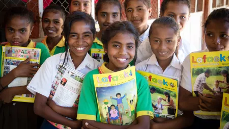 East Timorese Girls holding Lafaek magazines