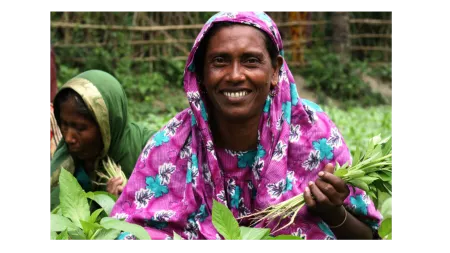 Bangladeshi woman in pink head scarf on farm