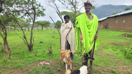 Man and woman with their goats in a rural community in Ethiopia