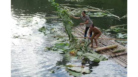 Vietnamese couple on raft with banana leaves