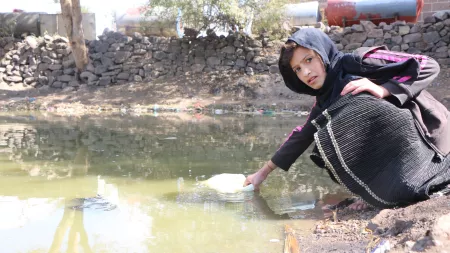 Girl fetching water in Yemen