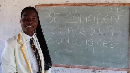 Zimbabwean girl in front of chalk board