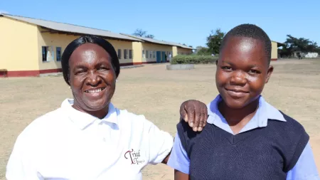 Zimbabwean teacher and school girl in school yard