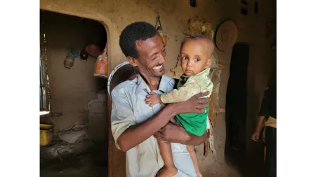 Ethiopia_Man holding and smiling at him