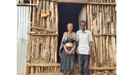 Ethiopia_Married couple standing at the doorstep of their home
