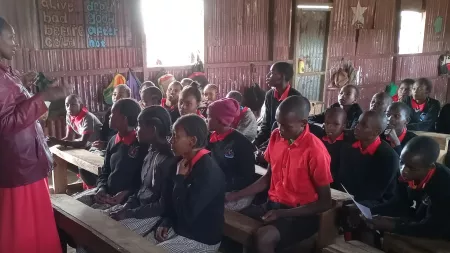 Children with teacher in classroom in Kenya