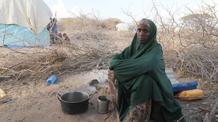 Woman sitting in a dry displacement camp in Somalia