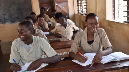 Benin_School students sitting at desks writing