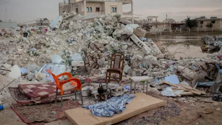 Empty chairs in front of rubble