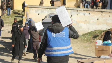 Man's back, carrying box on the shoulder 