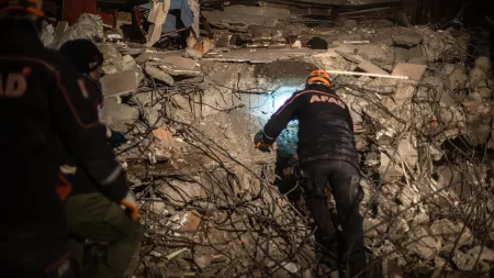 Rescue worker on top of rubble at night
