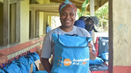 Vanuatu_Woman holding aid distribution pack