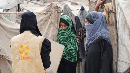 Yemen_Woman CARE worker interviewing women with face scarves in makeshift shelters