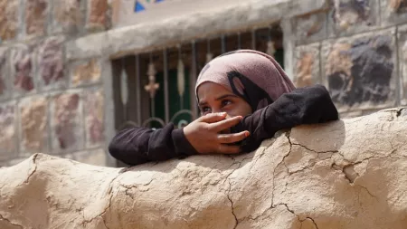 Yemeni girl looks over wall