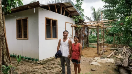 Philippines_Couple standing smiling outside almost complete house