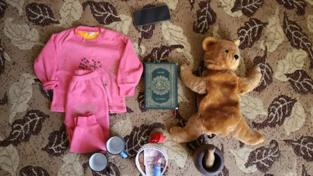 Syria_Teddy bear pink clothes motar pestel and qu'ran retrieved after earthquakes