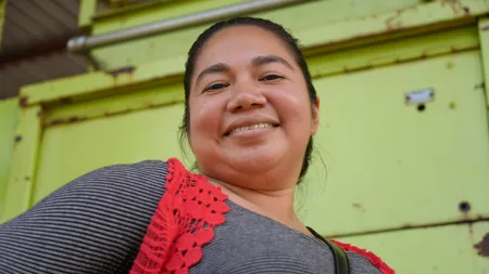 Honduras_Woman wearing crochet jacket smiling down at camera