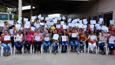 Hondurus_Group of women holding certificates in graduation ceremony