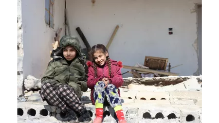 Syria_Two girls sitting in front of their destroyed home