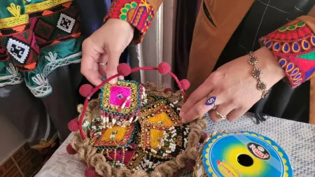 Afghanistan_Woman's hands holding sewed squares in baskets