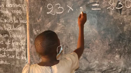 Benin_School girl writing on chalk board
