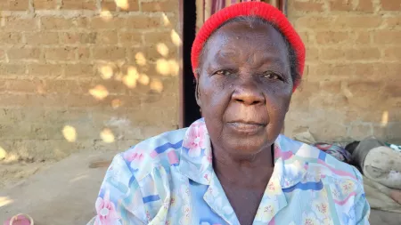 Zambia_Old lady with red beanie and powder blue and pink blouse